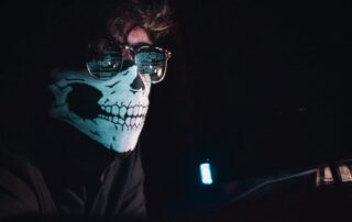 Hacker with face covering signifying need for businesses to make cyber security optimisations post-covid19
