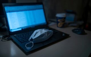 Face mask on laptop how to covid safe your business process