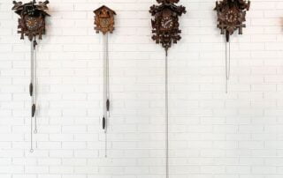 Several cuckoo clocks mounted on a wall